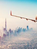 Private,Jet,Plane,Flying,Above,Dubai,City,In,Beautiful,Sunset